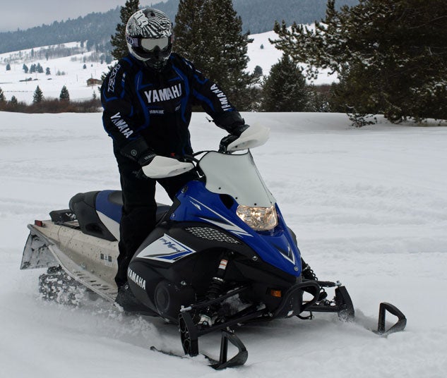 What should you consider before purchasing a pre-owned snowmobile?
