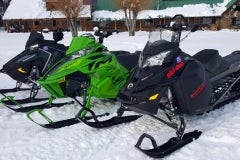 The three test units in front the Box Y Lodge, near Alpine, WY. Background, Polaris AXYS RMK Pro 163, middle, Arctic Cat M8000 Limited 162, and foreground, Ski-Doo XM Summit SP 163. All units with three-inch paddle tracks.