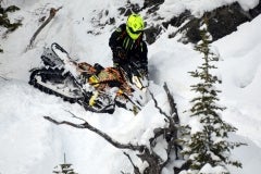Test rider for Snowmobile.com, Kevin Allred, takes an RRS-prepped G4 Summit X off a rocky hillside to give prove RRS' training is correct, as well as the balance the G4 delivers.