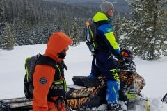 Luke Read (standing) and Aaron Roesler use the mountainside as their classrooms.  From the Ski-Doo G4 Summit X, both Read and Roesler, with tutoring from Rasmussen, teach fundamentals to both novice and experienced riders.