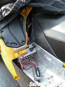 Alligator clips connect to the battery for a quick charge. The main unit can sit on the sled’s runningboard out of the way while charging.