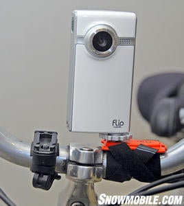 Use an 'action mount' and locate a Pure Digital Technologies Flip Video camcorder to your handlebars or helmet. (Image Courtesy Pure Digital Technologies Flip Video). Use an 'action mount' and locate a Pure Digital Technologies Flip Video camcorder to your handlebars or helmet. (Image Courtesy Pure Digital Technologies Flip Video).