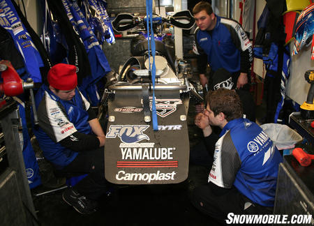 From left to right, mechanic Chris Sims and crew chief Adam Robinson consider the suspension setup options. Mechanic Jeff Torgerson is shown in the background.