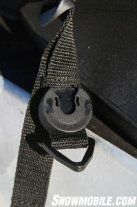 The nylon strap with the clasp easily slides over the cleat so the bag stays firmly attached to the sled.