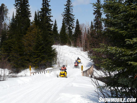 Bridges or culverts transport sleds over water crossings.