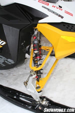 The dual A-arm front suspension carries the KYB 40-R shocks with remote reservoirs. On the remote reservoir chamber, the dial adjusts low-speed damping while a 17mm nut handles high-speed compression damping. At the top of the shock rod, the low-speed compression damping dial adjuster is located at the top of the shock rod.