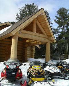 Snowmobiles parked outside of Laurentian Lodge.