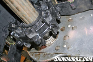 The driveshaft is inserted through the chain mounting bracket and into the chaincase.