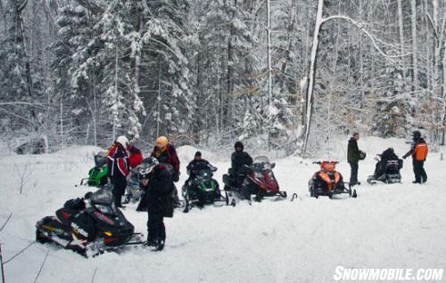 Ontario Snowmobilers Checking Mobile Trail Guide