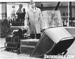 Allan Hetteen stands alongside the second ever Polaris snowmobile.