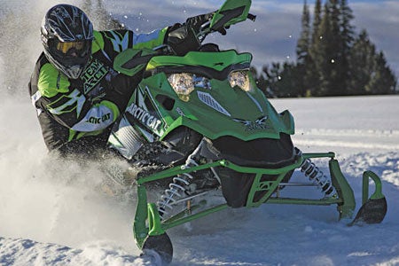 Arctic Cat's Sno Pro 500, like Cat's other Sno Pro race-inspired models, has a laydown (horizontal) steering post, which, as you can tell, allows the driver to lean and properly leverage the snowmobile's handlebars for aggressive cornering - this keeps the snowmobile flat. This steering post concept is not shared with Cat's M-series and Crossfire models.