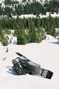 Bret Rasmussen on a steep descent works the M into a horizontal crosscut as he feathers the mountain sled down the slope while looking the opportune time to upright the M into a power climb.