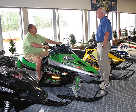 Summertime visitors to the World Snowmobile Headquarters see the latest sleds alongside vintage ones.