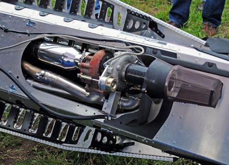 The PUSH Turbo installs under the seat and dumps exhaust into the tunnel. It uses an oil feed off the engine for lube.